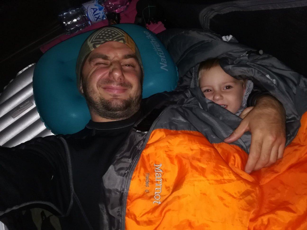 Папа и дочка спят в палатке в спальных мешках